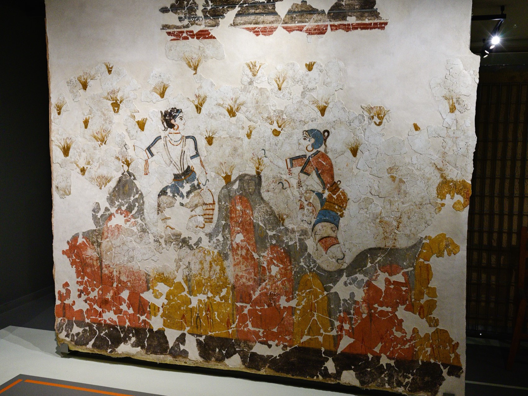 Detail from the Saffron Gatherers fresco from Akrotiri, used here as a sourced Aegean Bronze Age artwork divider.